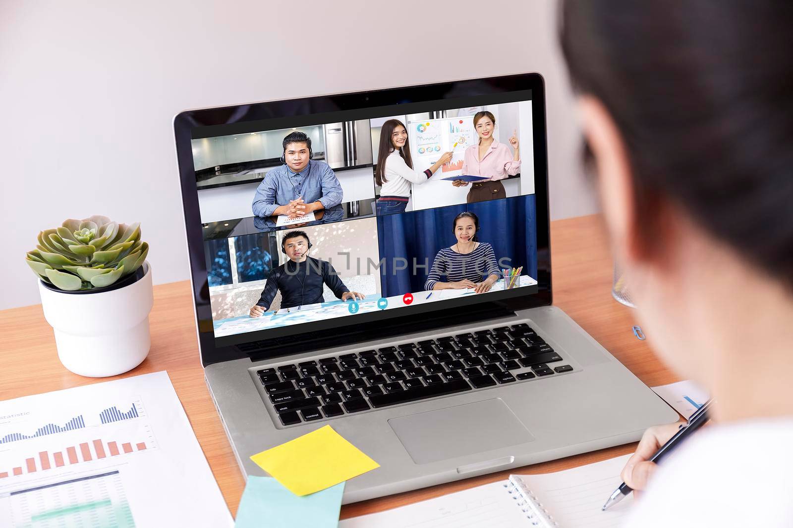 Businessman and businesswoman analysis financial chart with videoconference online meeting. Hand of businesswomen using laptop meeting with diverse colleagues. Covid-19 working from home. With copy space banner