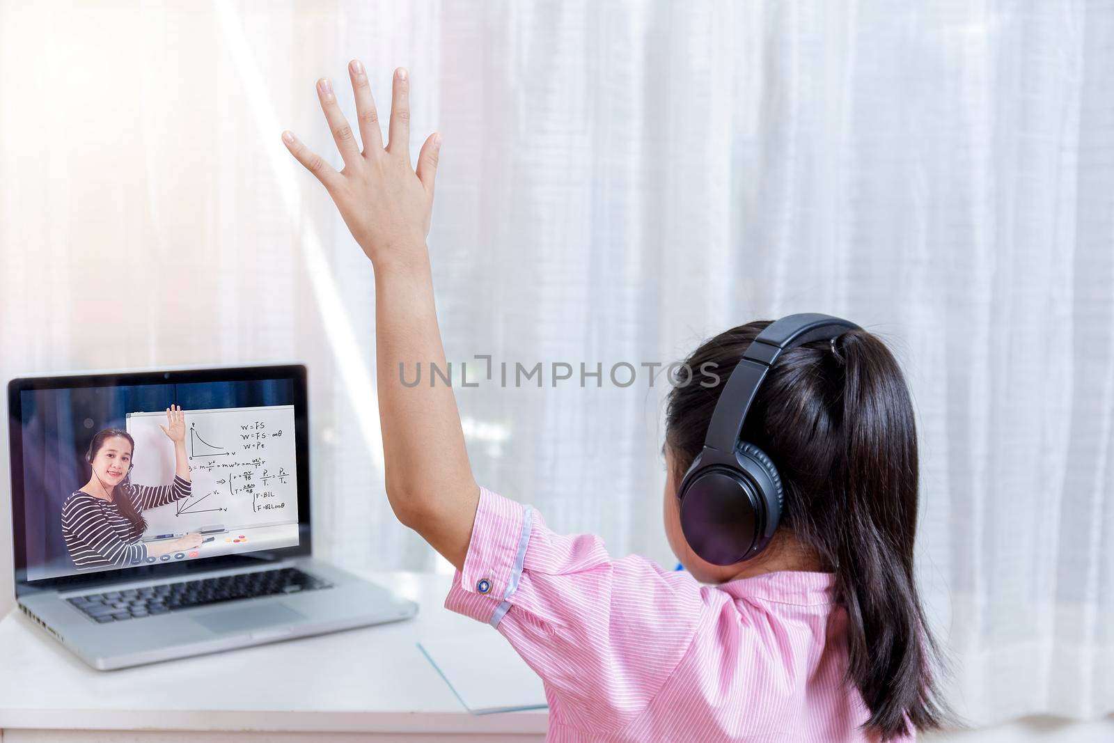 Asian little girl student learning via internet online class from school teacher duling covid-19 outbreak. Man teaching math by whiteboard. Homeschool learn from home concept