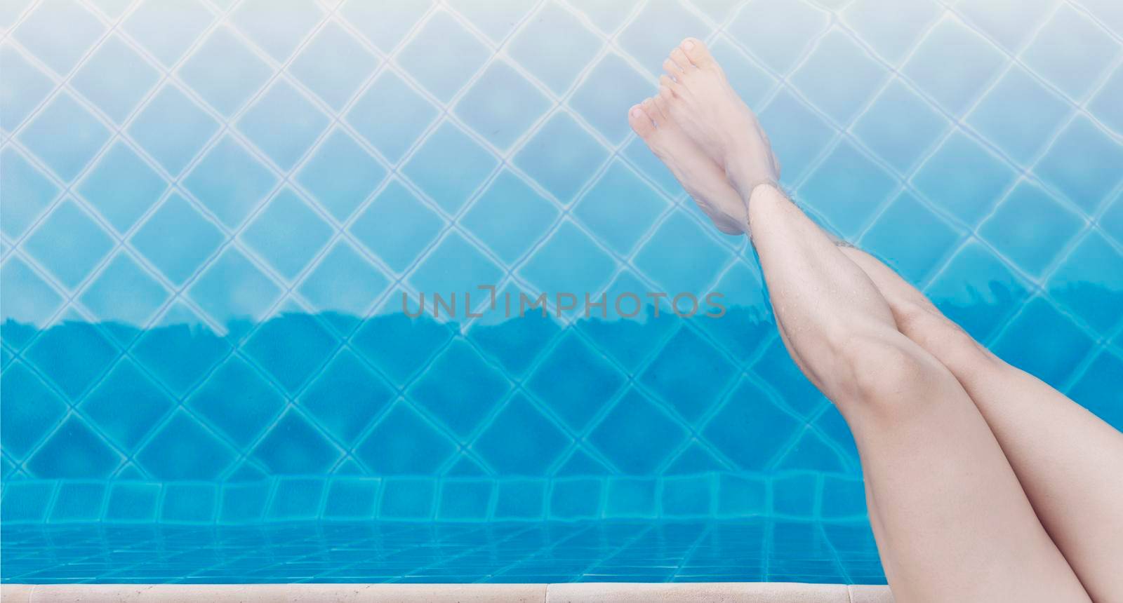 Close up and select legs.  Top view Women lifestyle relaxing and happy in luxury pool outdoor, summer time at resort in the hotel. Summer holiday and Vacations concept. with copy space