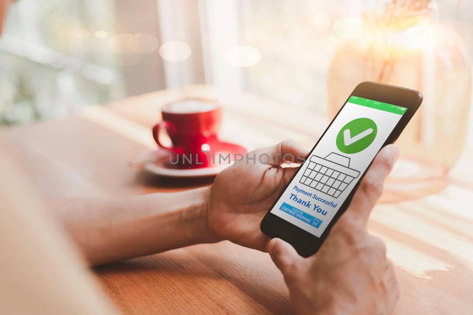 close up woman using mobile phone to shop online. Women are happy to shop online. The mobile screen shows the payment is complete. Women are happy to shop online in coffee shops. positive feeling