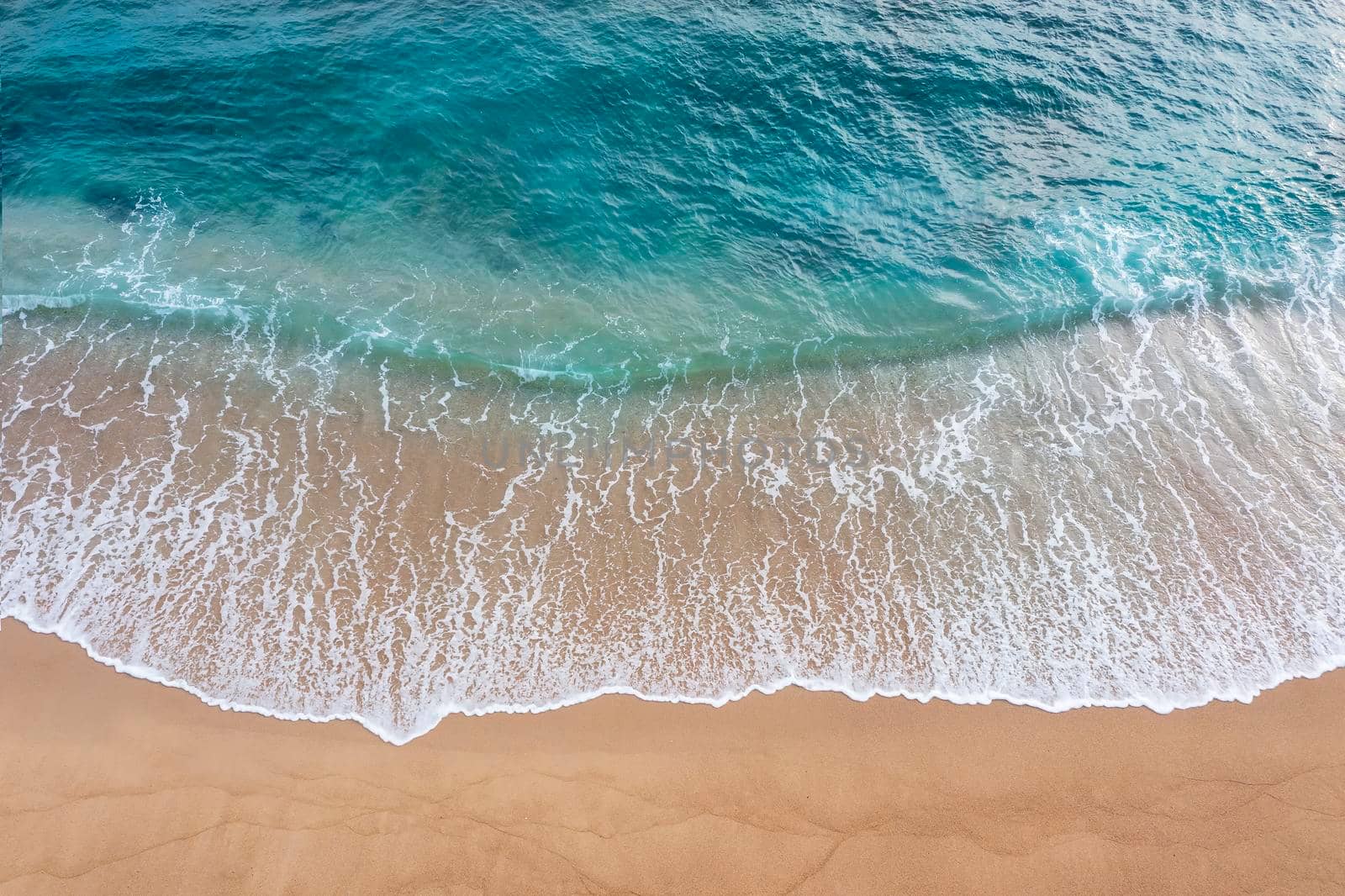Abstract of beautiful soft wave come to beach background. Soft wave of blue sea on sand beach background.