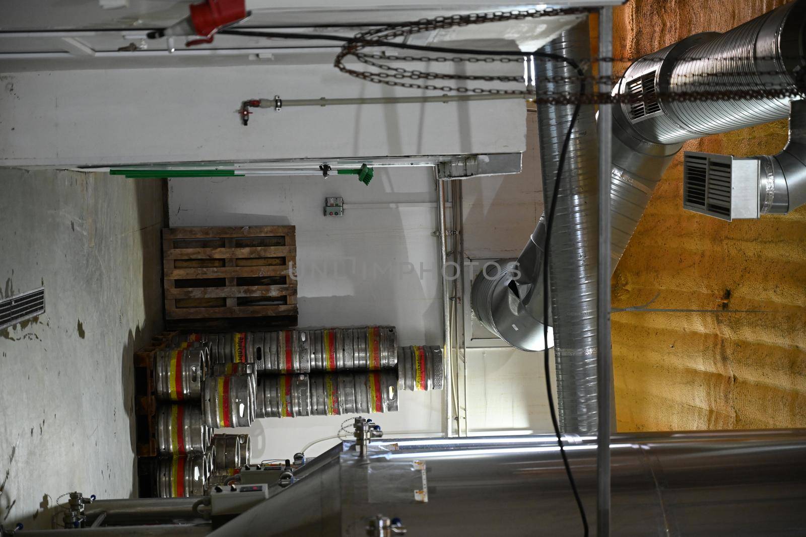 in the warehouse of the brewery beer kegs