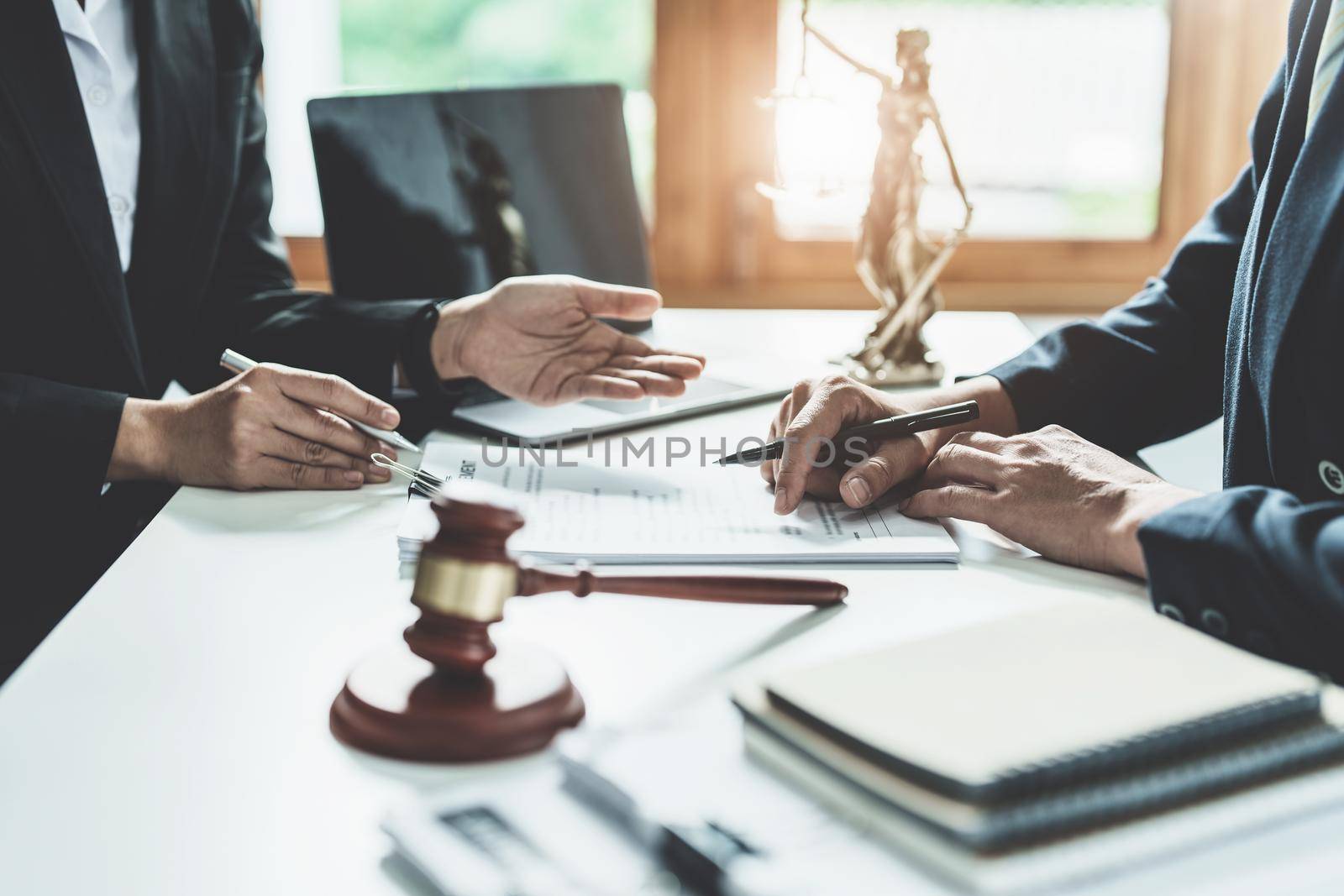 Law, Consultation, Agreement, Contract, Attorney or Lawyer holding a pen is consulting with a client to explain the pattern of answering questions before going to court to decide a lawsuit. by Manastrong