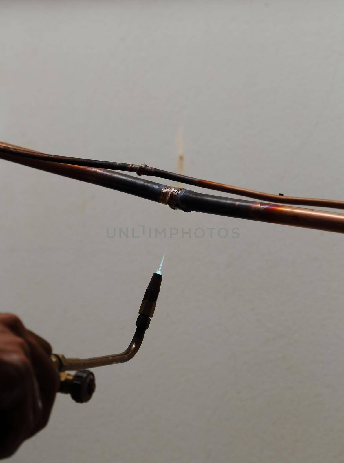 repairman welding copper pipes by geargodz