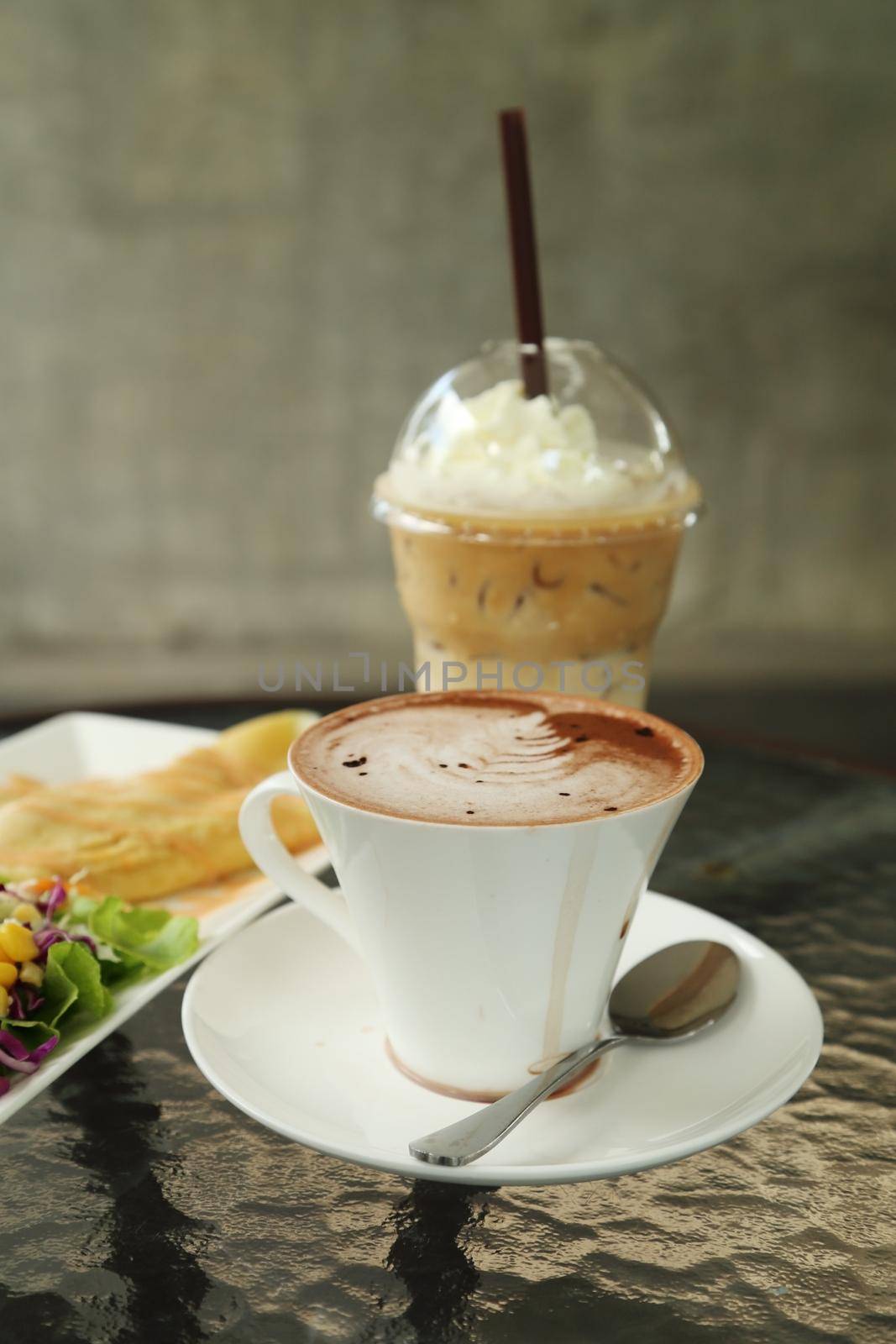 cup of hot chocolate with ice coffee  in cafe