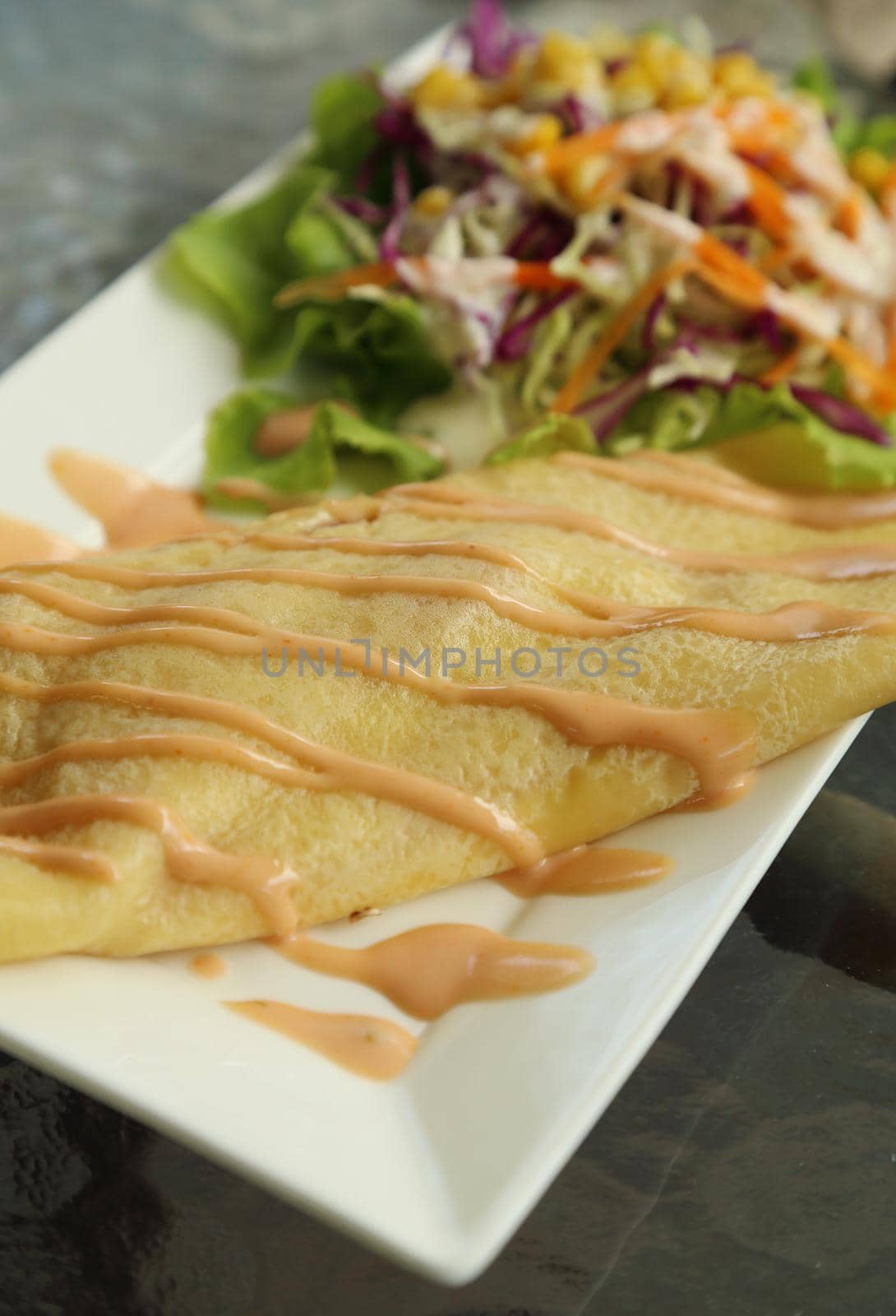 Crepe Cake with salad in cafe