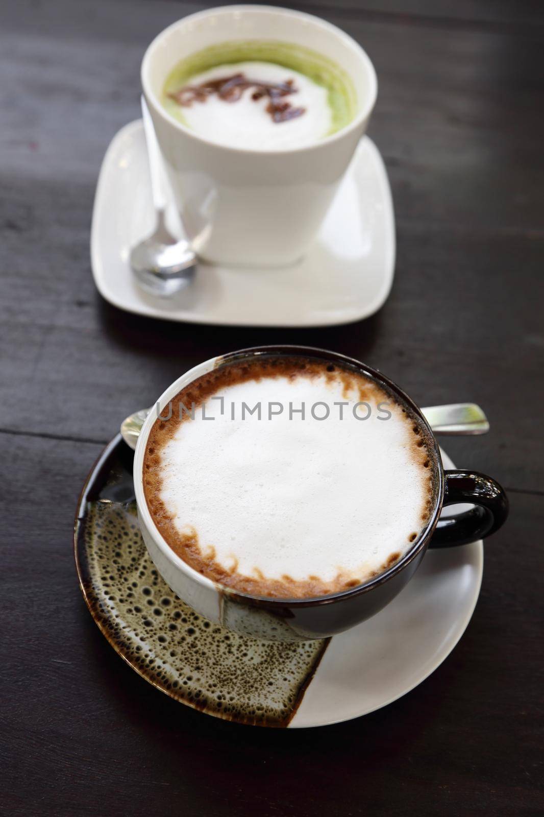 cup of hot coffee with green tea background