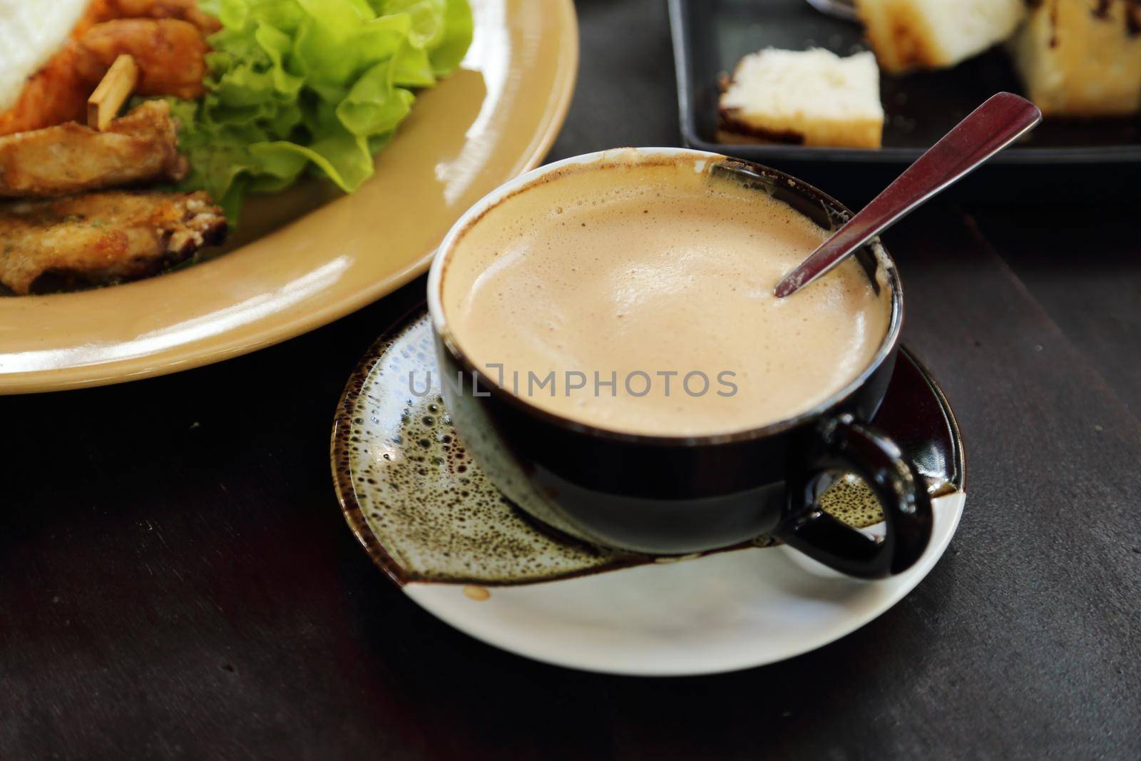 cup of hot coffee with cream on table