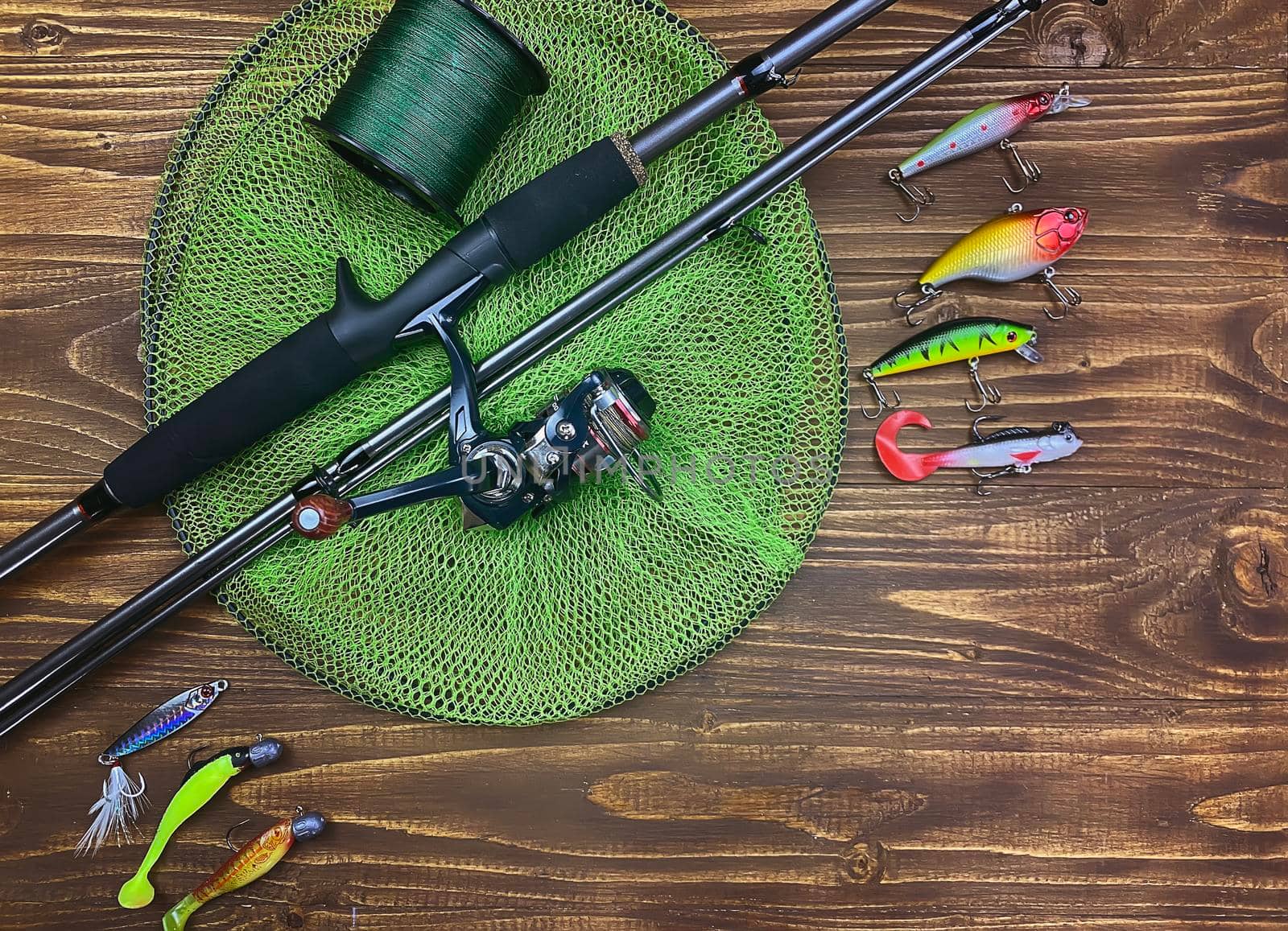 Fishing tackle. Float, wobbler, bait hooks, on a wooden background. Selective focus