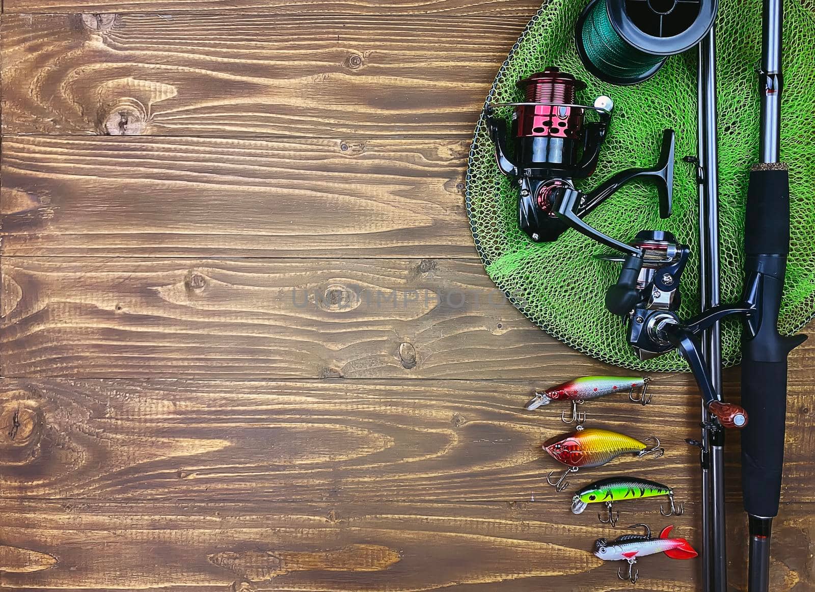 Fishing tackle. Float, wobbler, bait hooks, on a wooden background. Selective focus