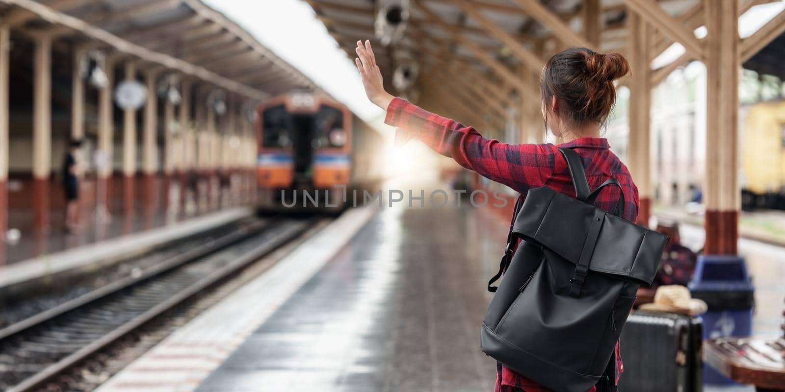 Pretty Young traveler woman planning trip at train station. Summer and travel lifestyle concept