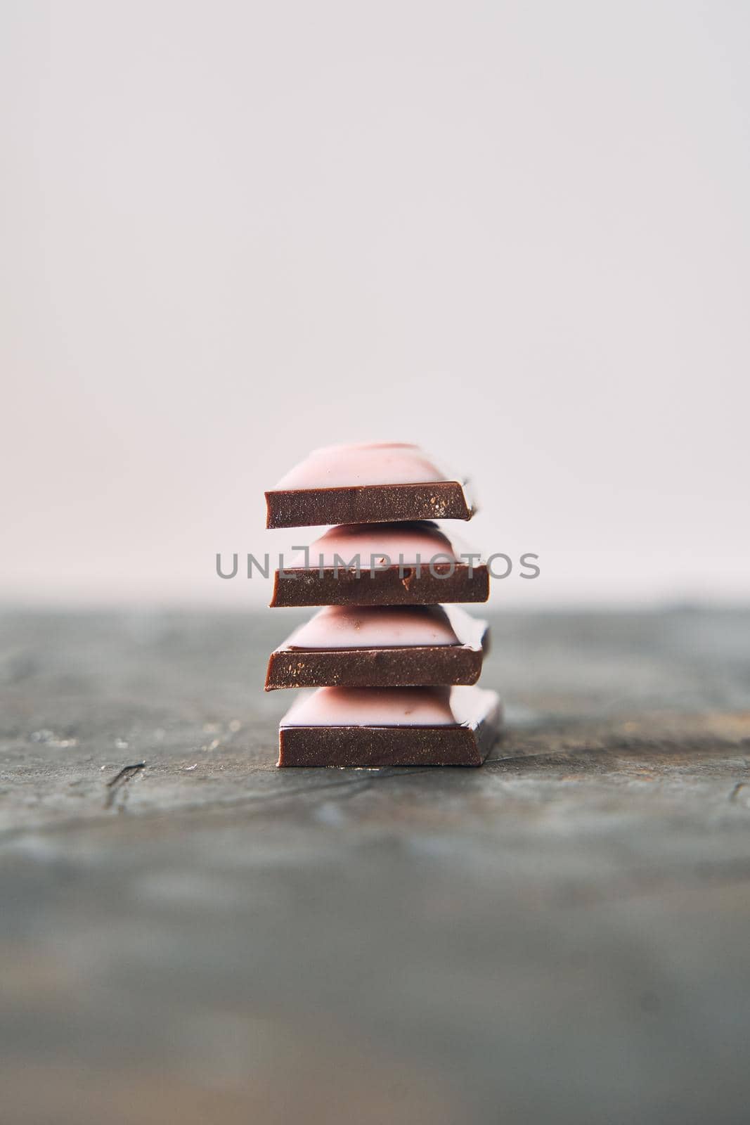 Selective Focus on Four Chocolate Slices on a Dark Background. by driver-s