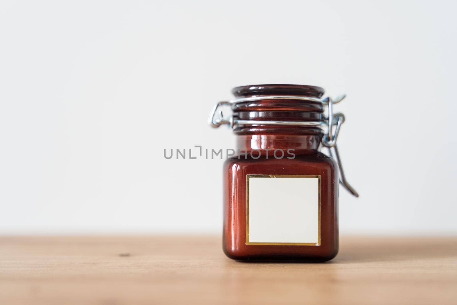 Scented candle in a glass jar on a white background by driver-s