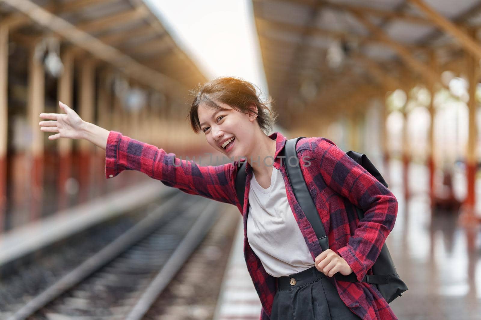 Pretty Young traveler woman excite and planning trip at train station. Summer and travel lifestyle concept