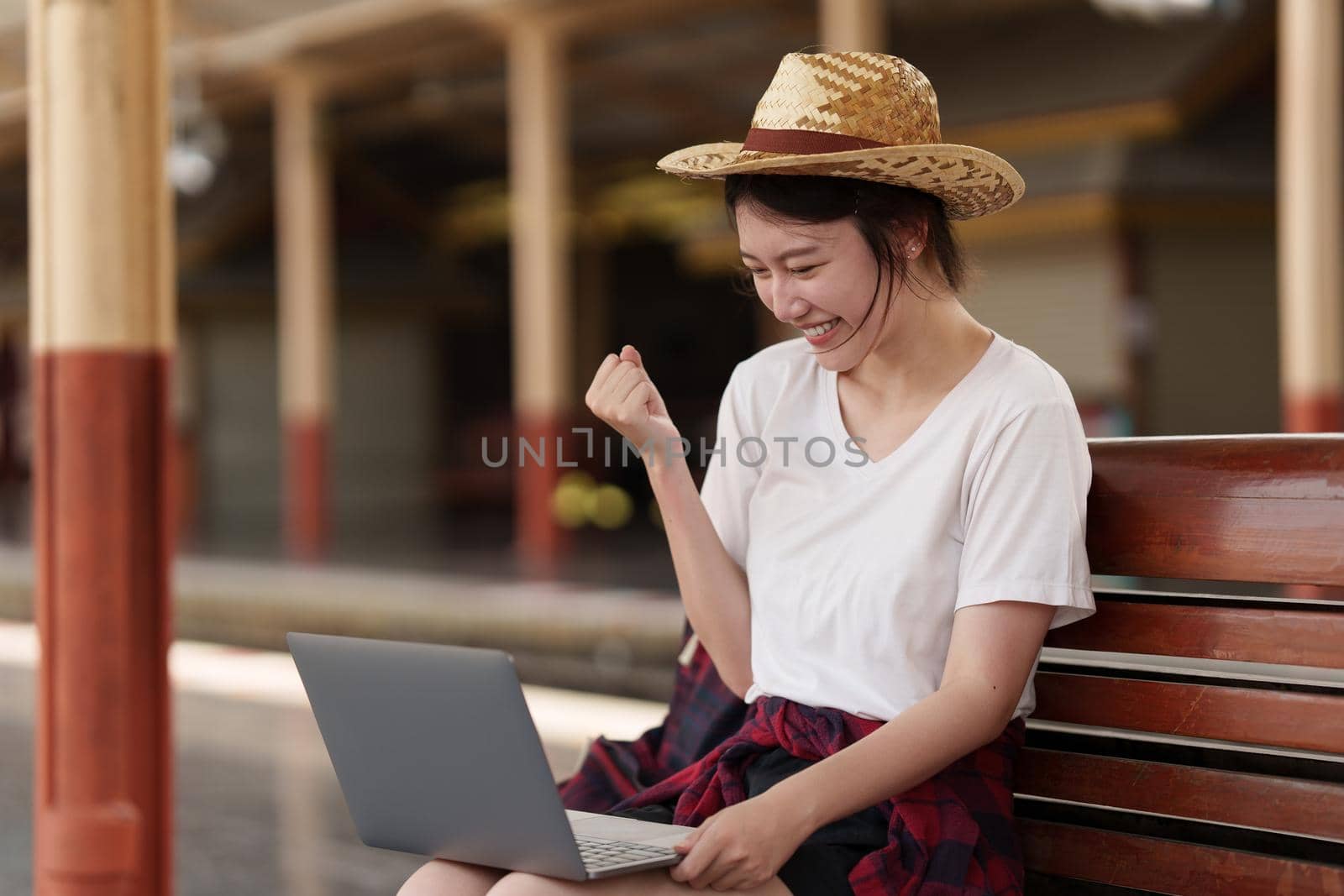 Pretty Young traveler woman excite and planning trip at train station. Summer and travel lifestyle concept