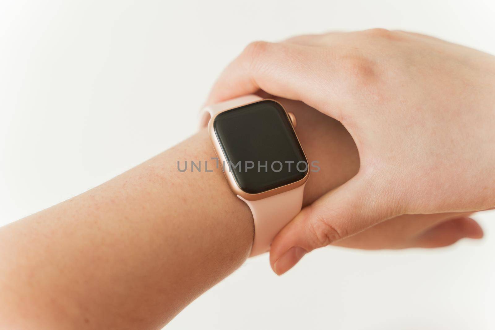 Kaliningrad, Russia - March 9, 2021: Smart clock on hand at a young woman. Close-up of Apple Watch SE series.