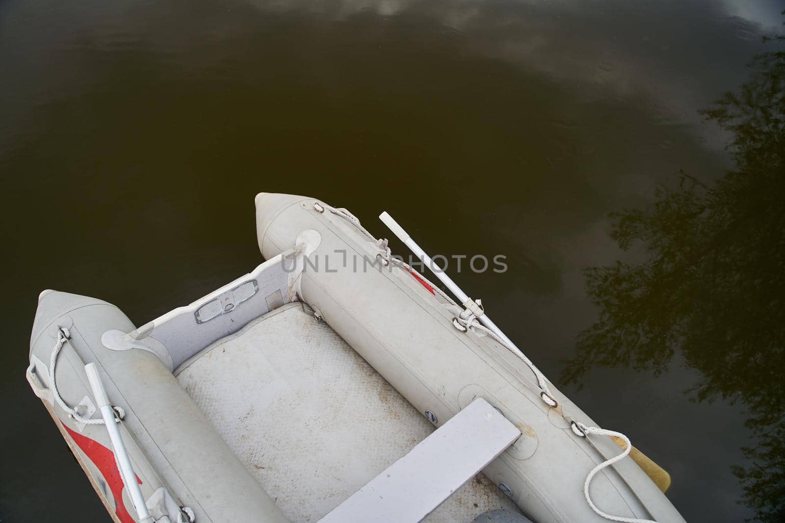 A gray rubber boat moored at a wooden pier. High quality photo
