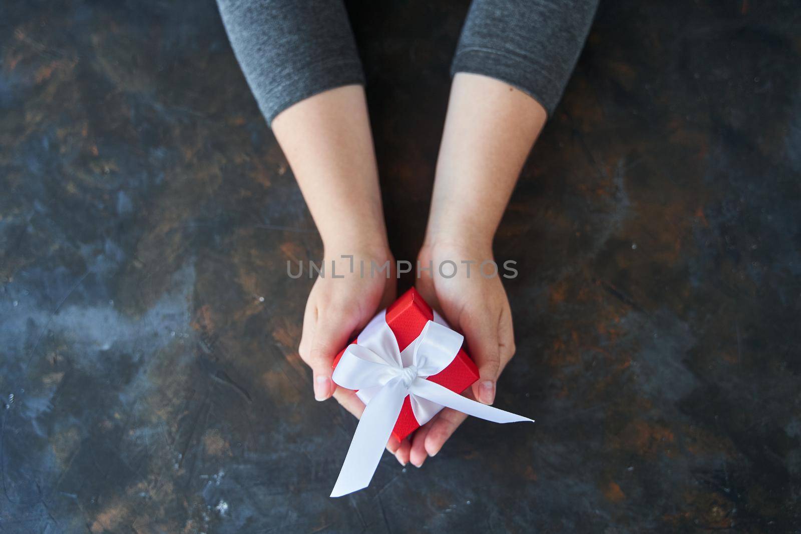 Woman holding small red present box in hands. by driver-s