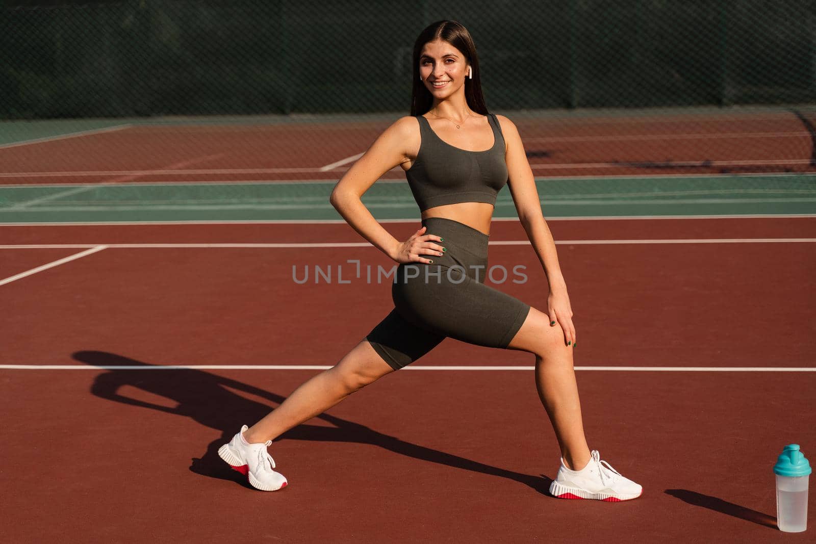 Workout exercise outdoor lunges. Attractive girl trains outside. Sports lifestyle