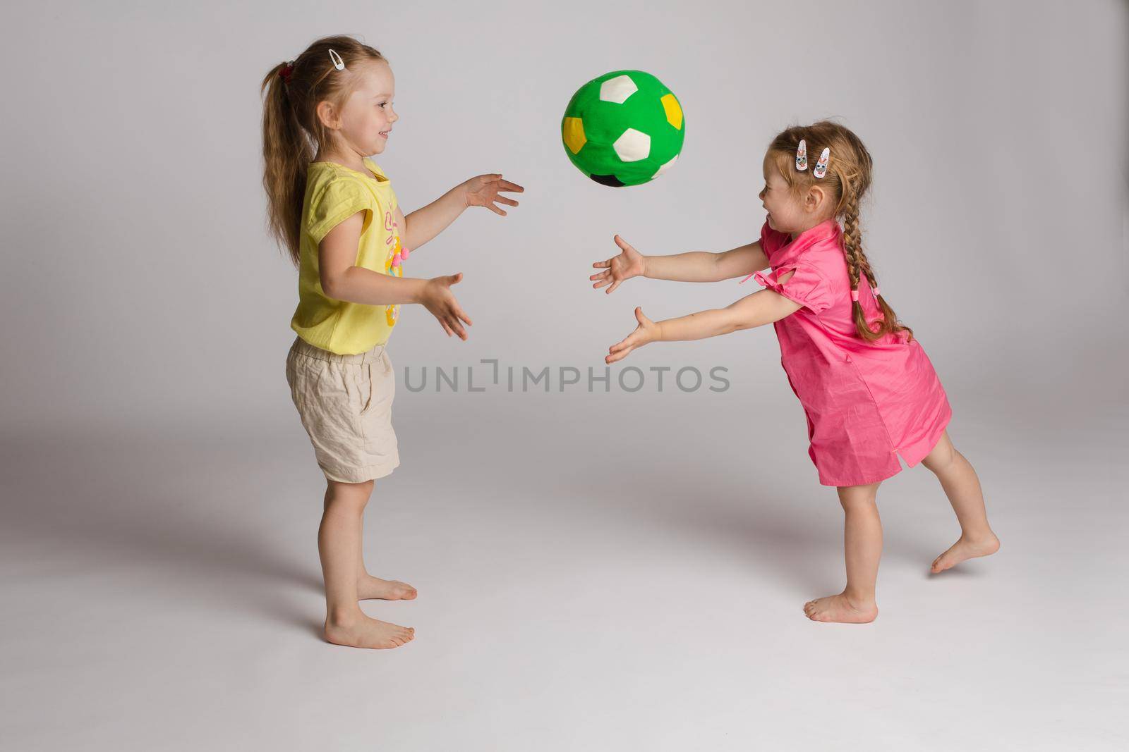 Ccheerful kids throwing and catching ball. Concept of happiness and game. by StudioLucky