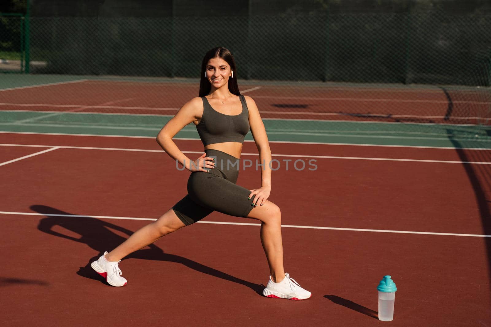 Workout exercise outdoor lunges. Attractive girl trains outside. Sports lifestyle. by Rabizo