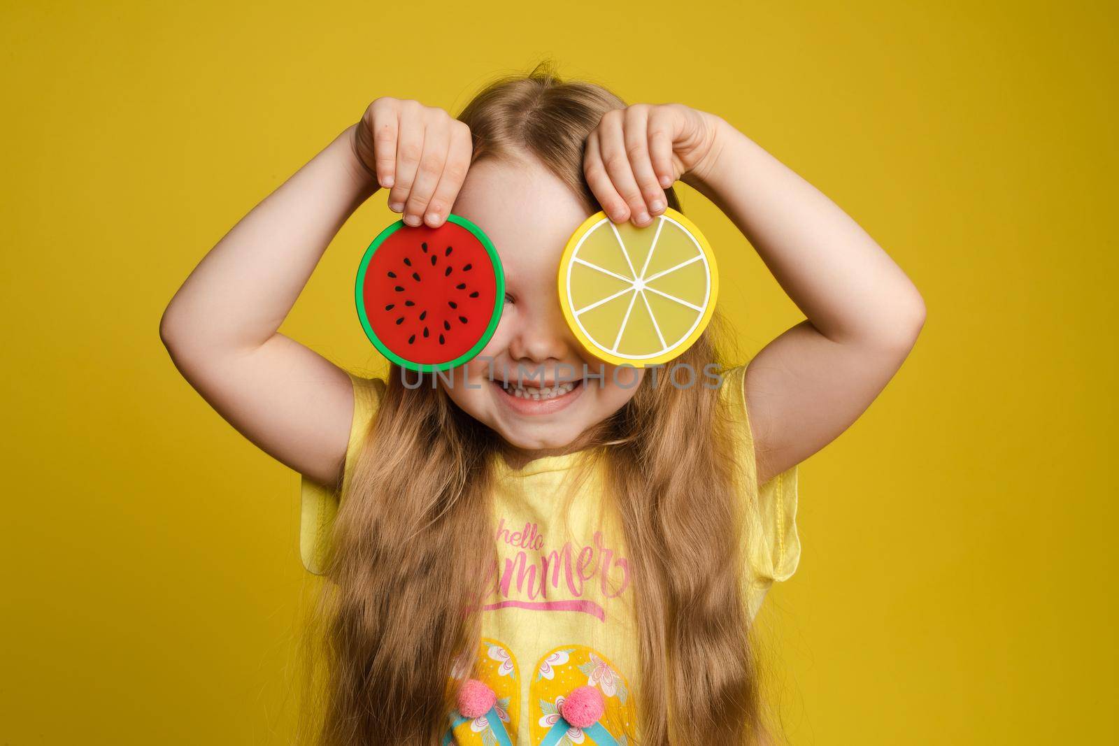 Ggirl standing on yellow background and closing eyes by StudioLucky