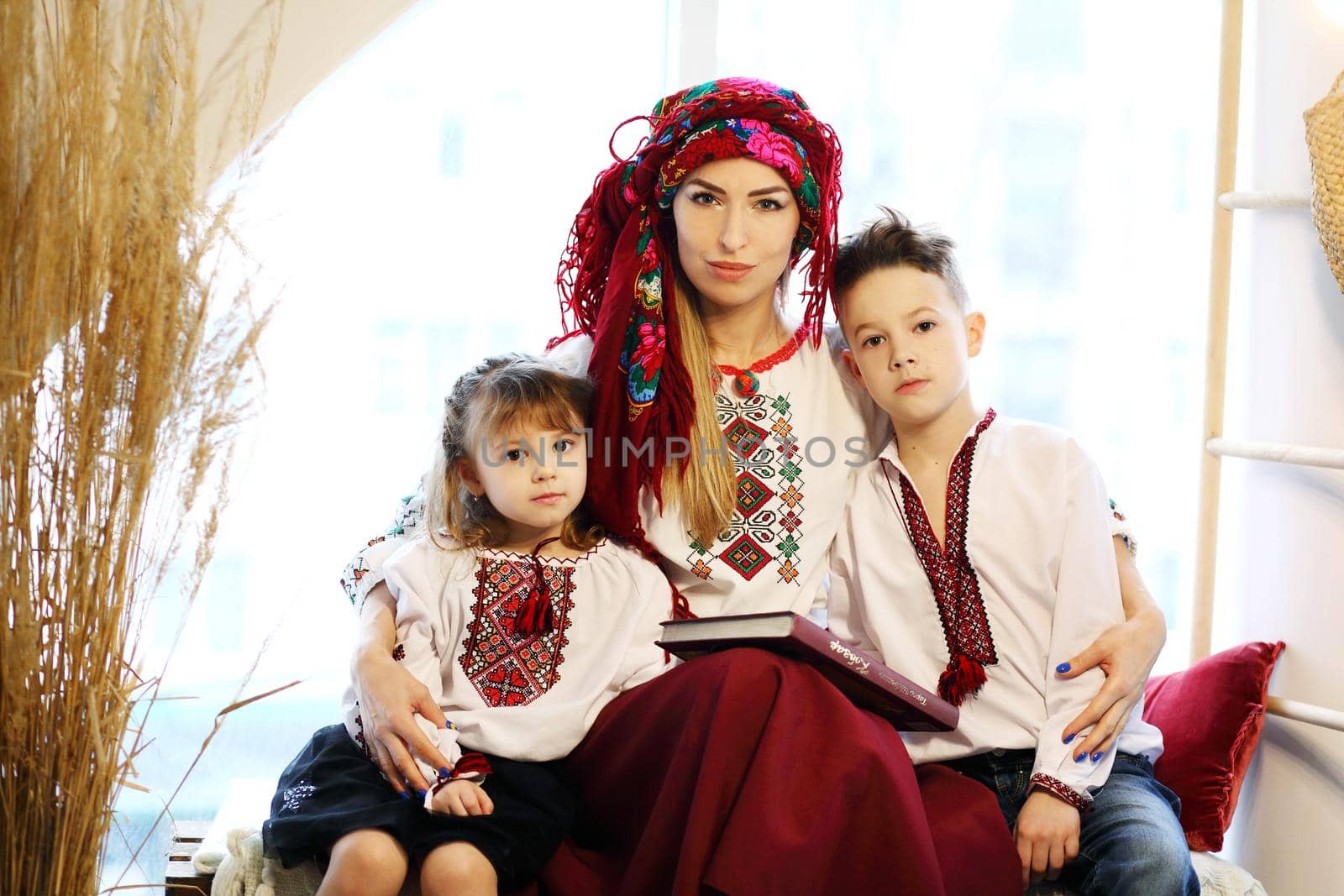 Ukraininan family wearing ethnic style embroidered shirt, modern derivative from traditional Ukrainian vyshyvanka.
