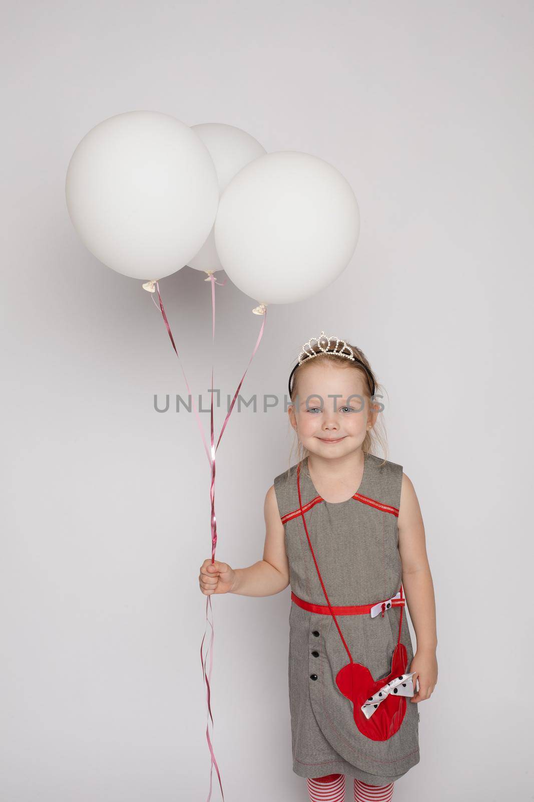 Sweet little girl with air balloons in studio. by StudioLucky