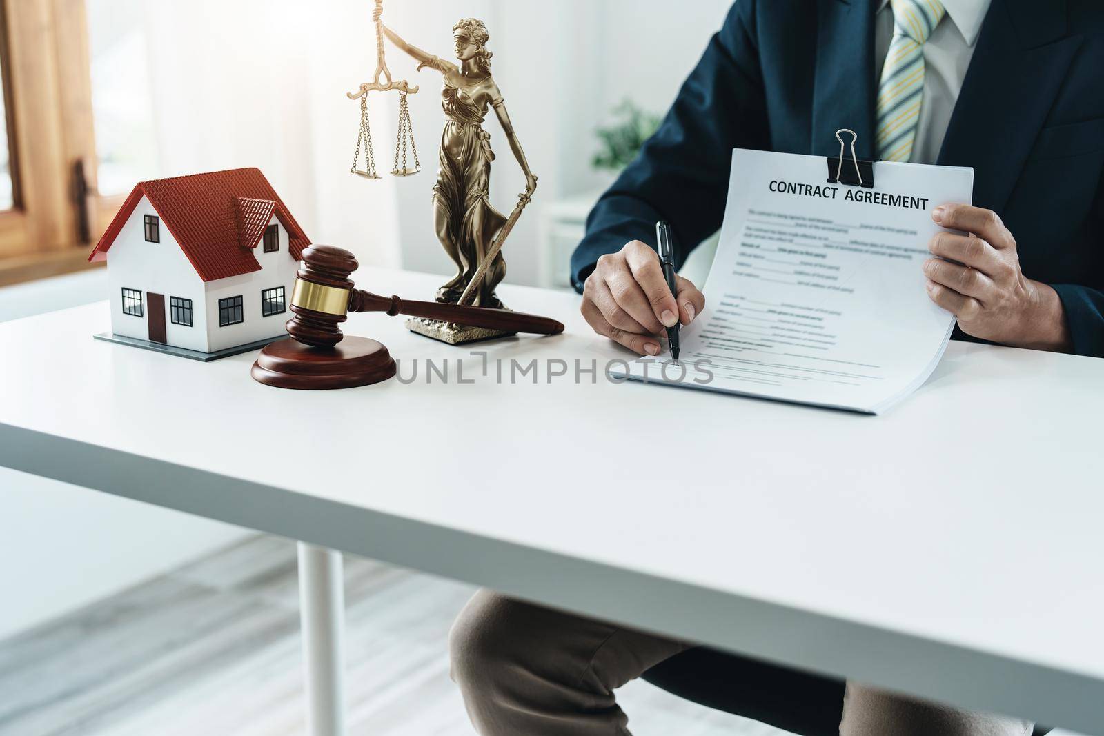 Law, Consultation, Agreement, Contract, Concept Attorney or lawyer holding pen pointing document is sitting on the chair with a client's complaint to determine the house and land in court.