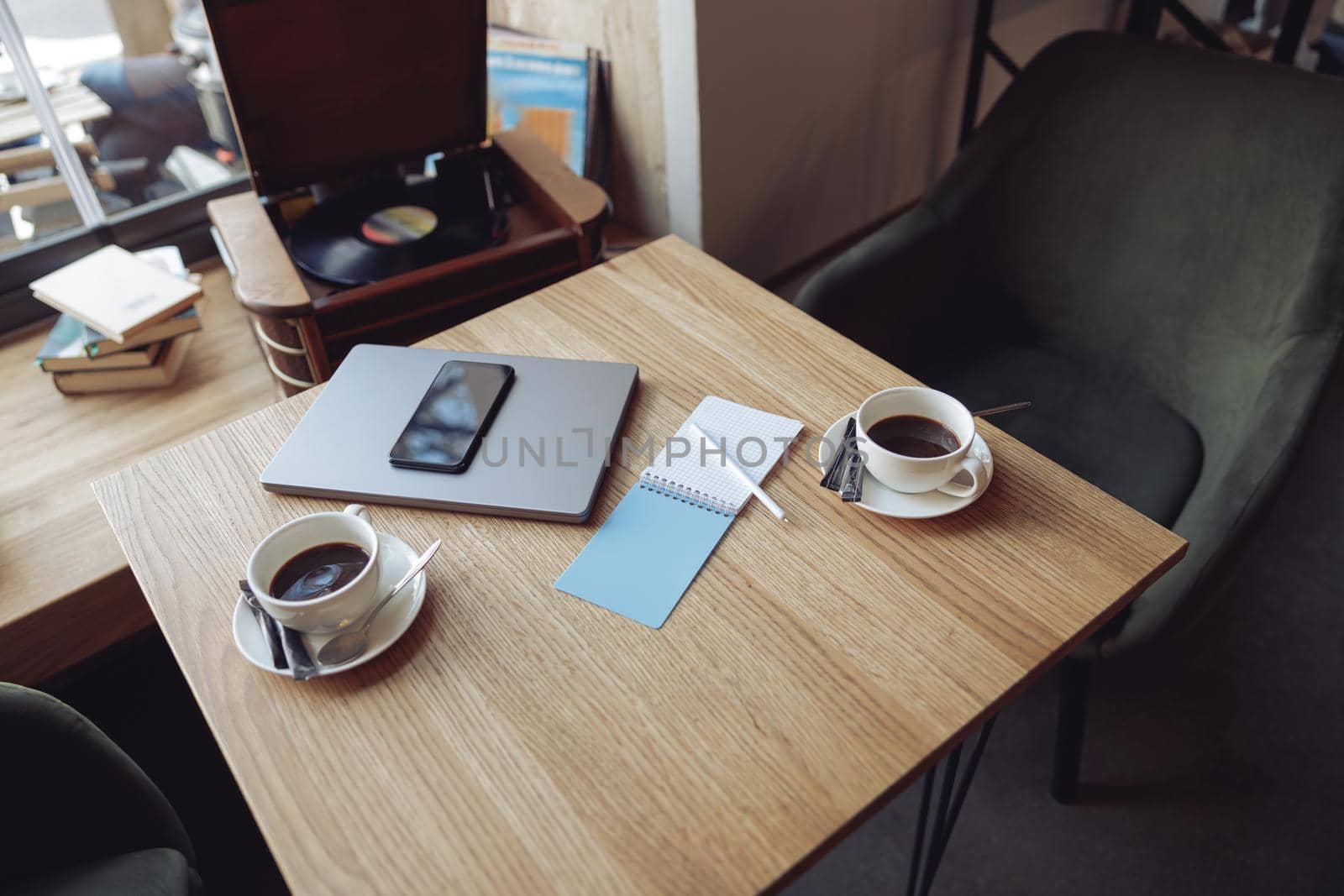 View from above on table with two white coffee cups and business stuff. Laptop and phone. Top view.