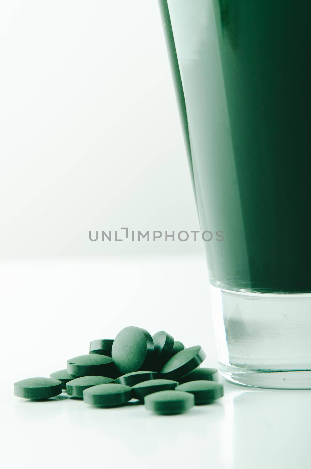 minimalist glass with water and spirulina powder. High quality photo