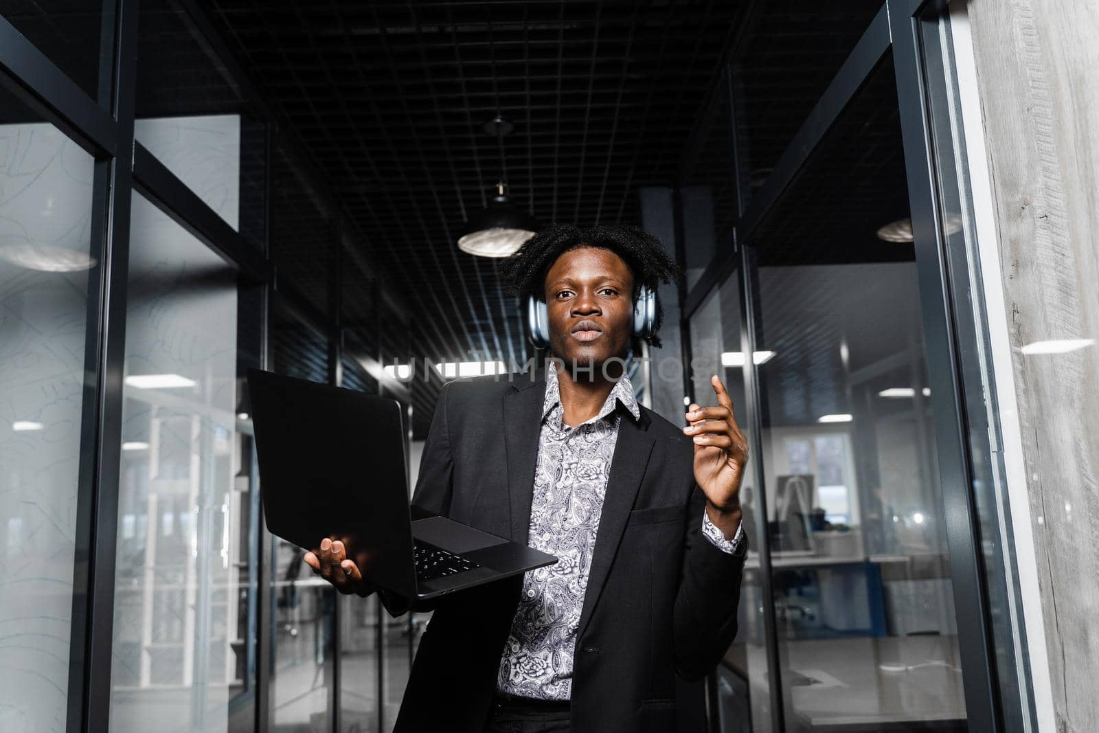 Black man in headphones is listening music and dancing. Party lifestyle