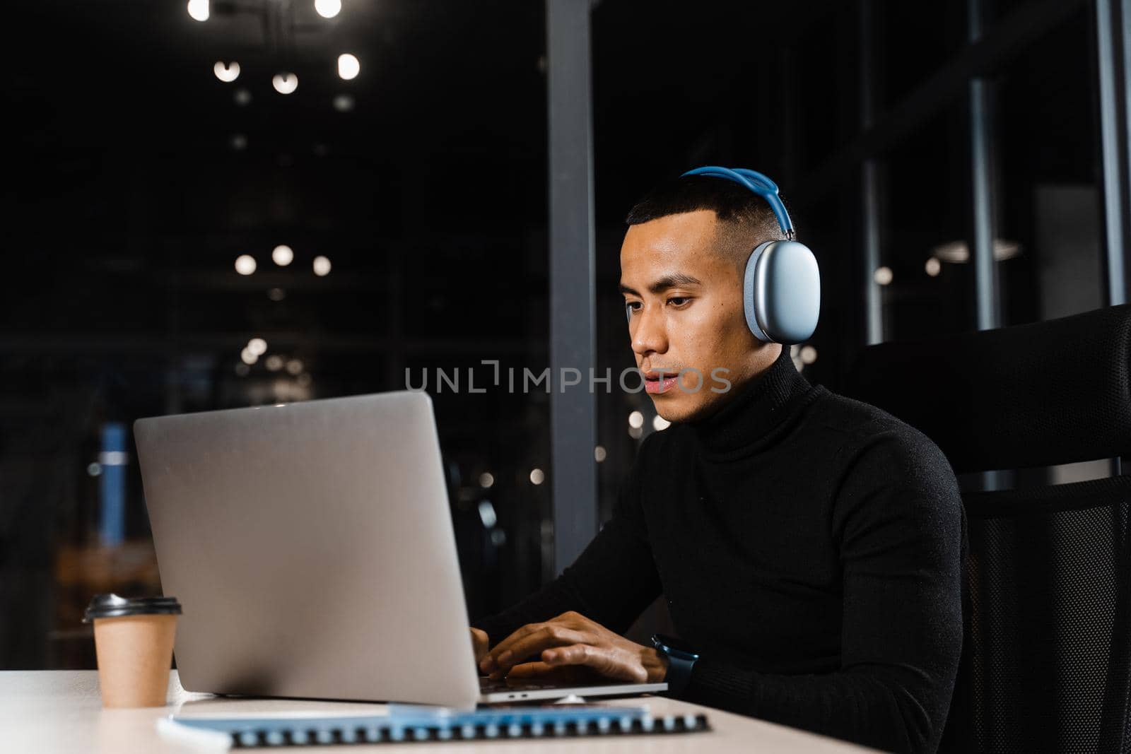 Distance education for Asian student. Handsome filipino studying online at laptop at home