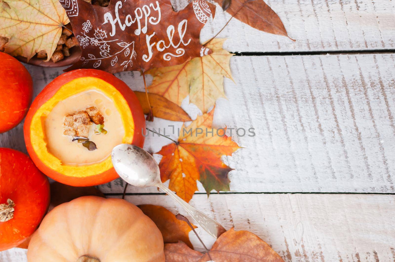 pumpkin cream soup in autumn scenery. High quality photo