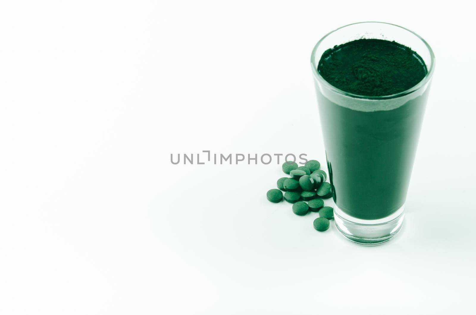 minimalist glass with water and spirulina powder. High quality photo