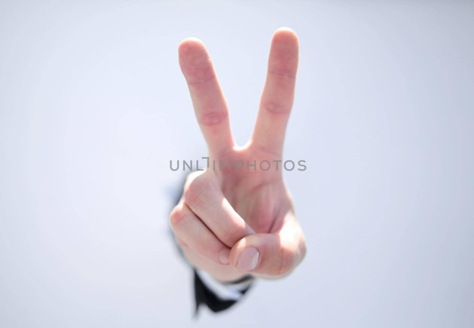 close up. businessman showing a gesture of victory. by asdf