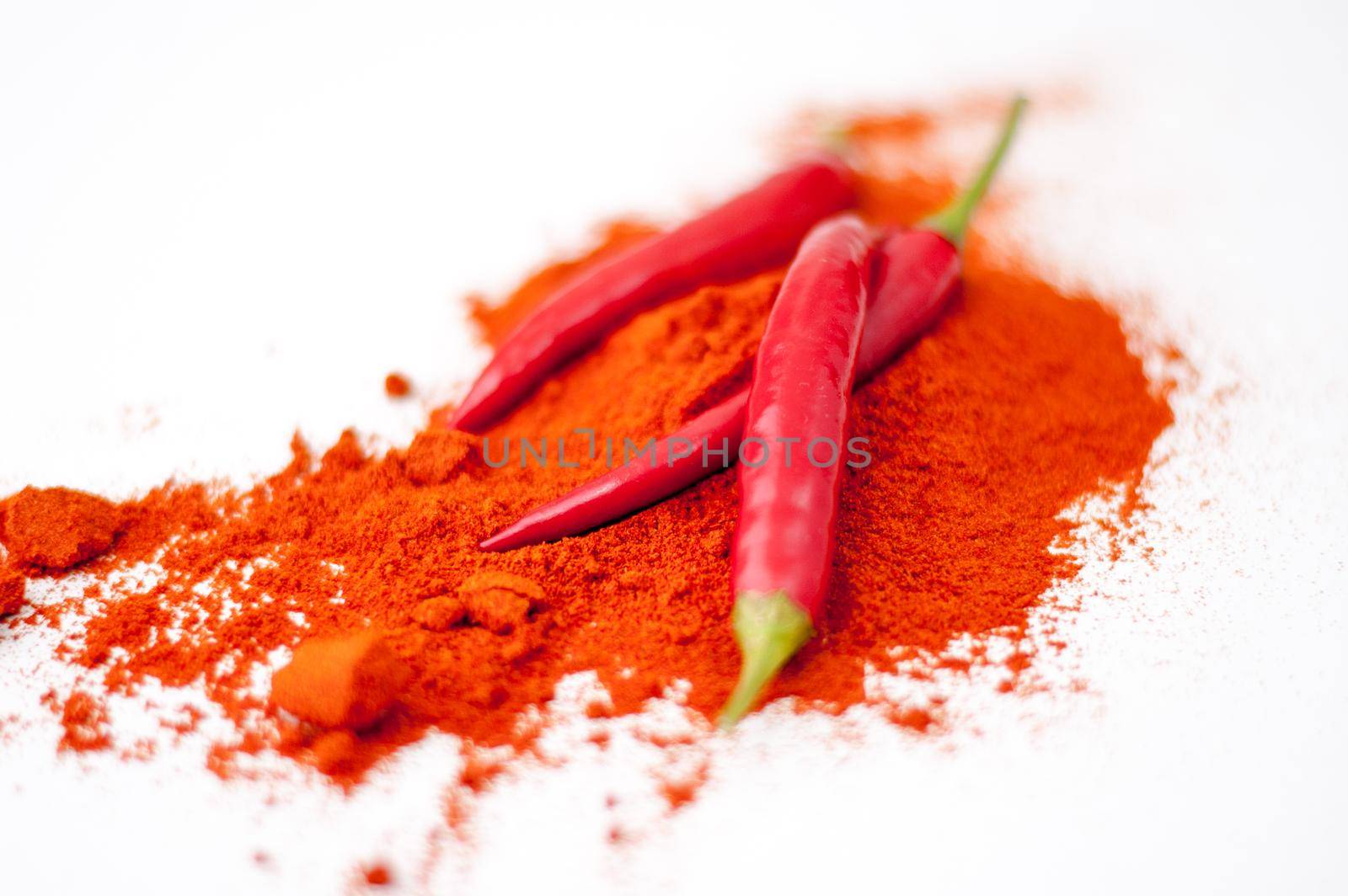 fresh red hot pepper and powder on a white background. High quality photo