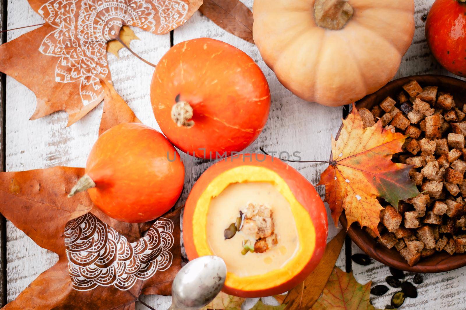 pumpkin cream soup in autumn scenery. High quality photo