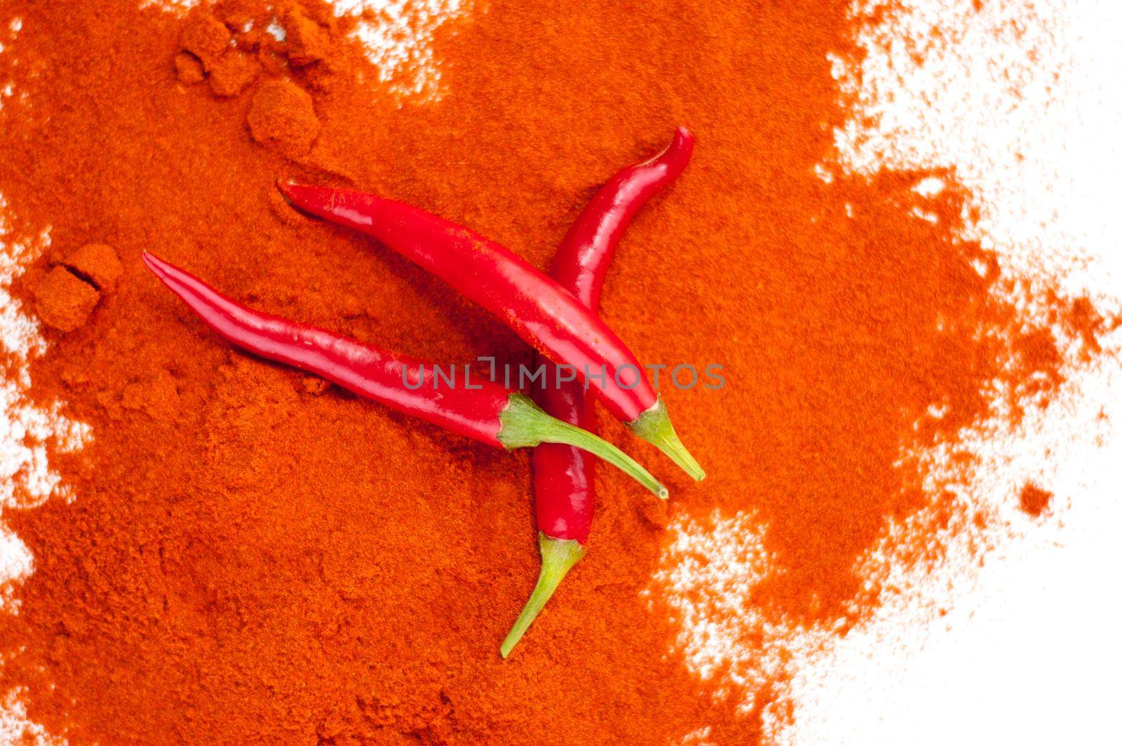 fresh red hot pepper and powder on a white background. High quality photo