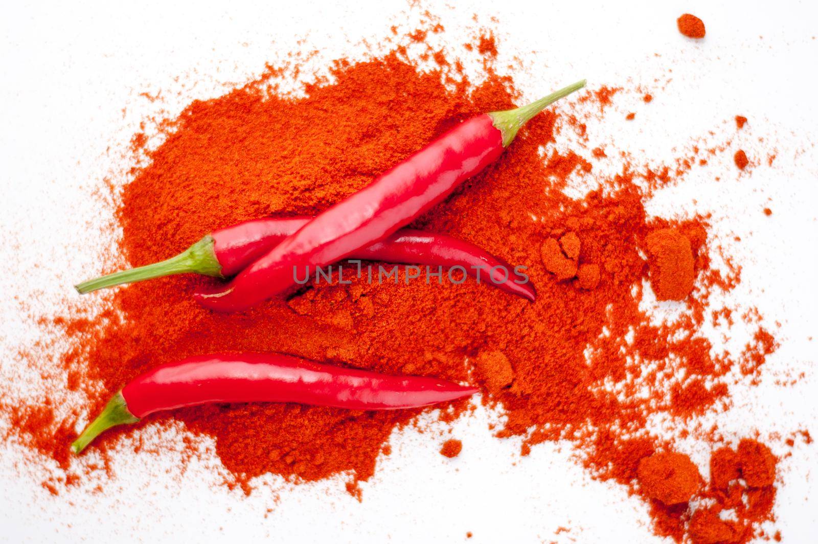 fresh red hot pepper and powder on a white background. High quality photo