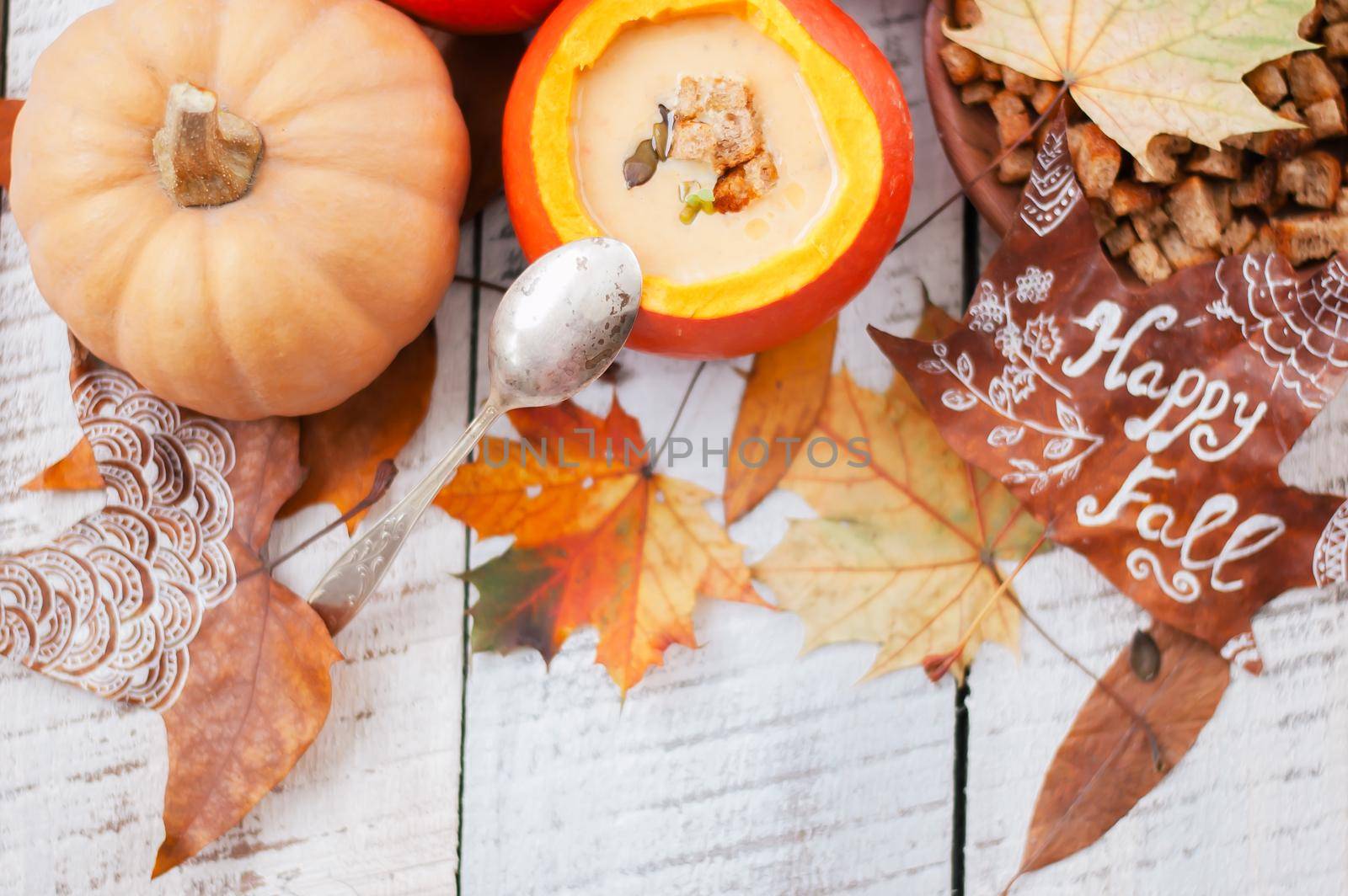 pumpkin cream soup in autumn scenery. High quality photo