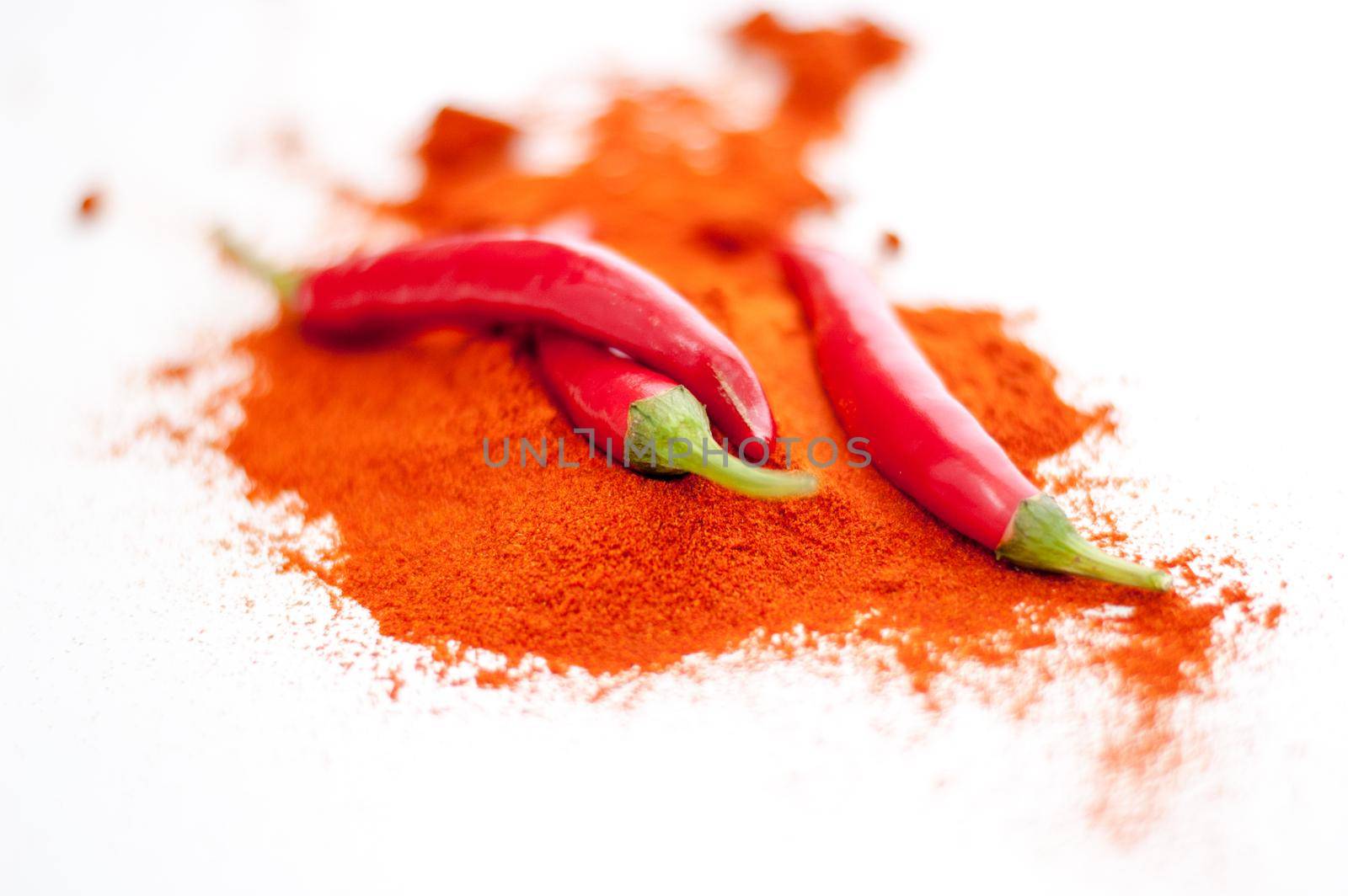 fresh red hot pepper and powder on a white background. High quality photo