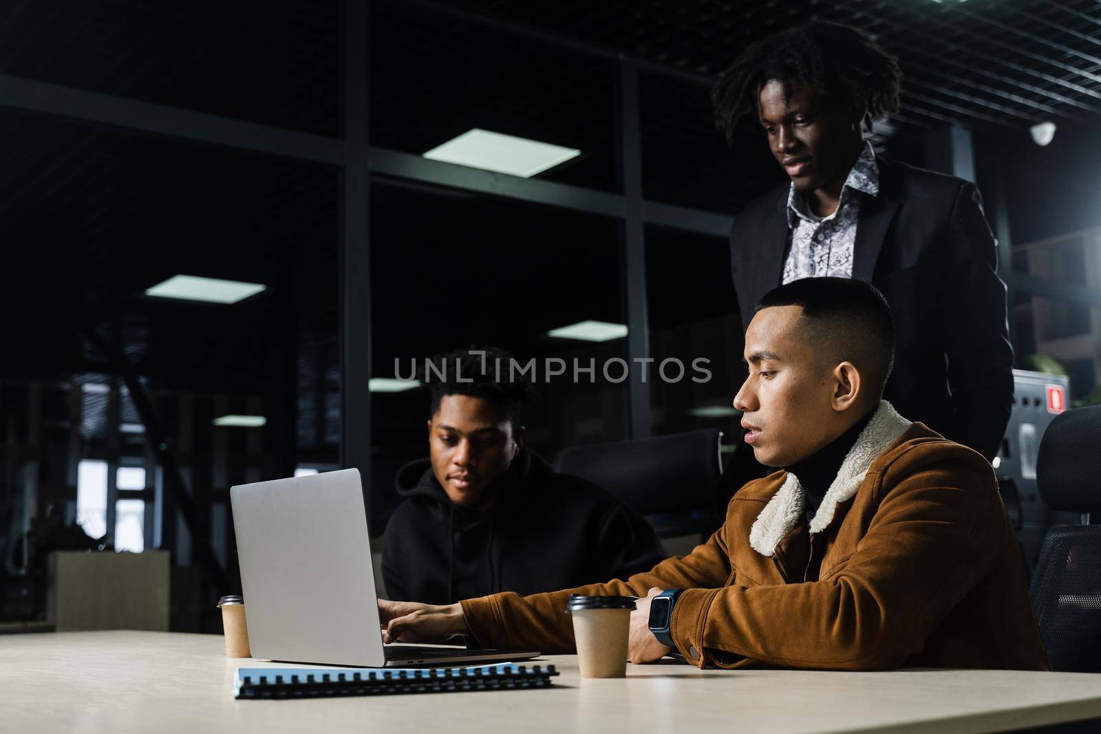 Teamwork online with laptop. Black african and asian colleagues. 3 multiethnic business men watch video conference with colleagues and employer