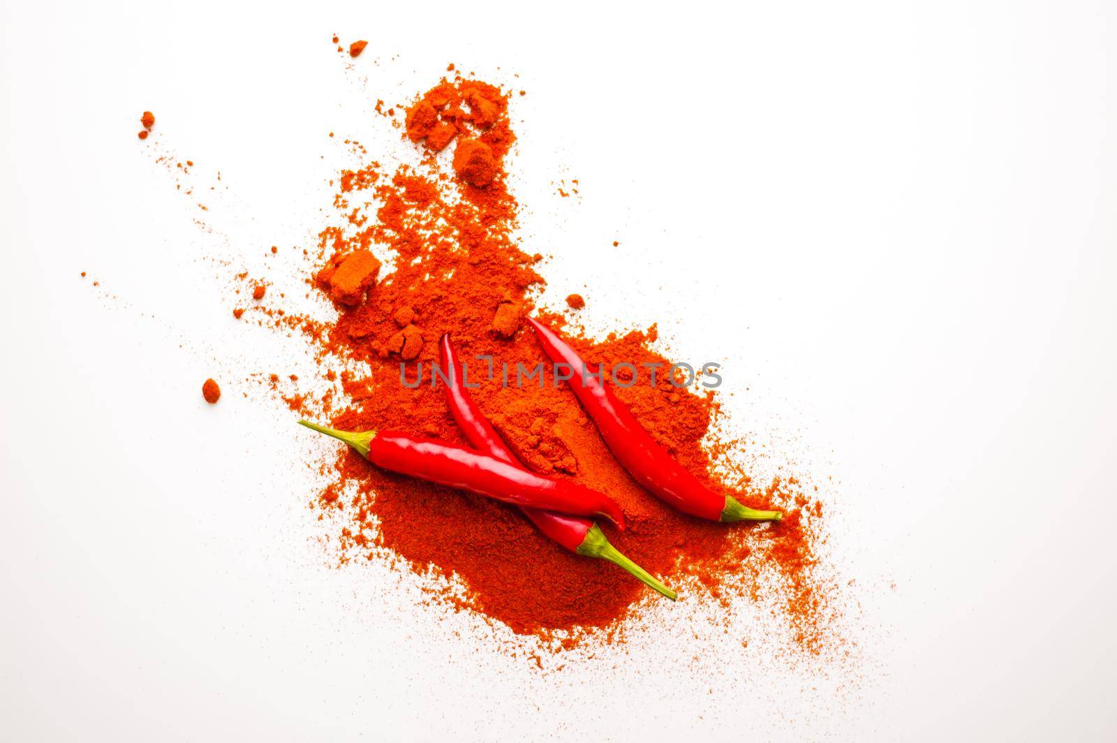 fresh red hot pepper and powder on a white background. High quality photo