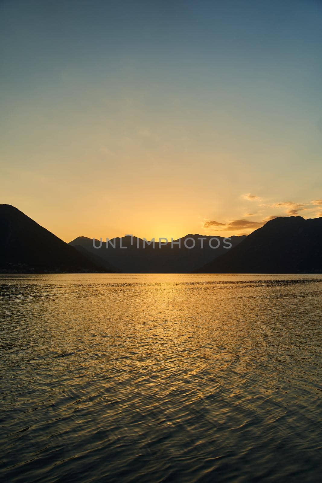 View of the sunset in Boko-Kotor Bay in Montenegro. Silhouettes of mountains. High quality photo