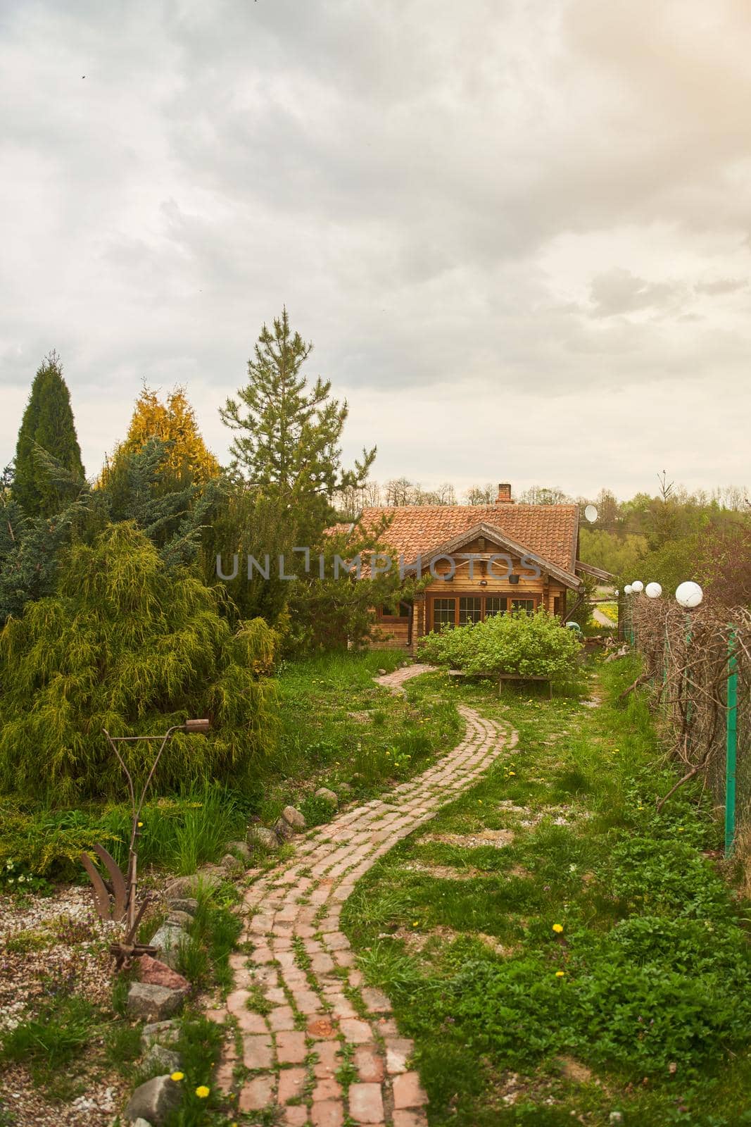 Brick winding path to a wooden house. High-quality photo
