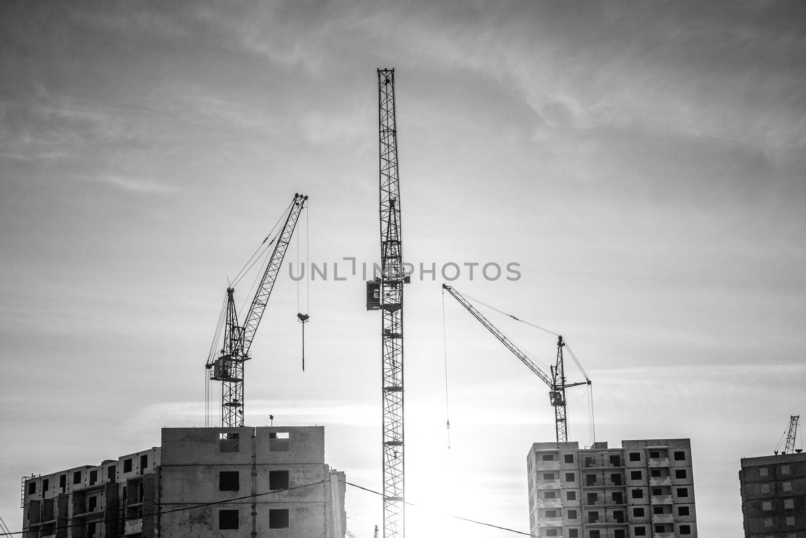 Modern building under construction and powerful crane