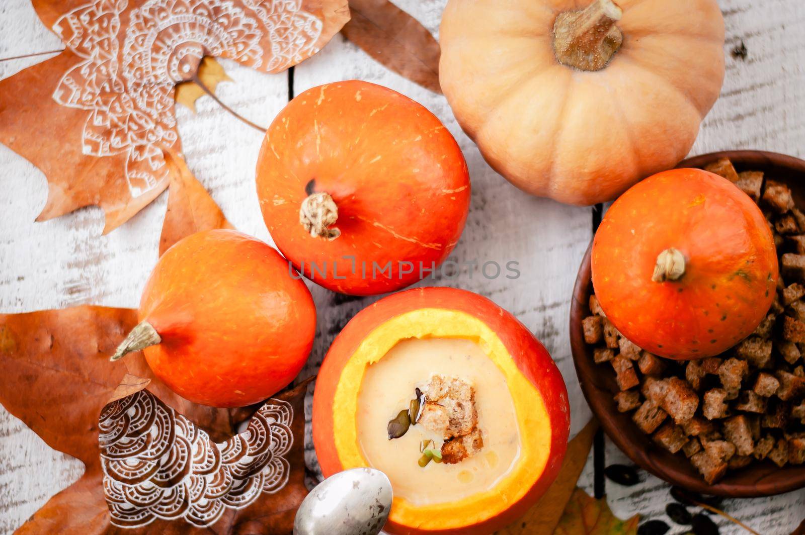 pumpkin cream soup in autumn scenery. High quality photo