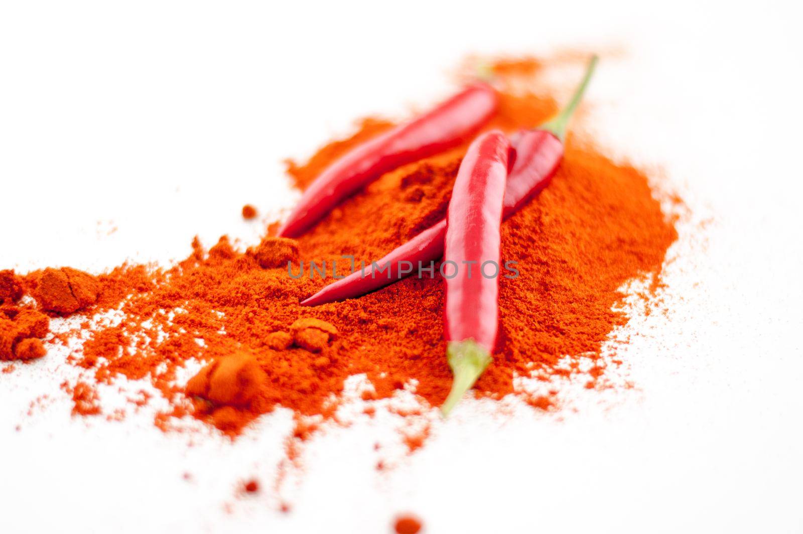 fresh red hot pepper and powder on a white background. High quality photo