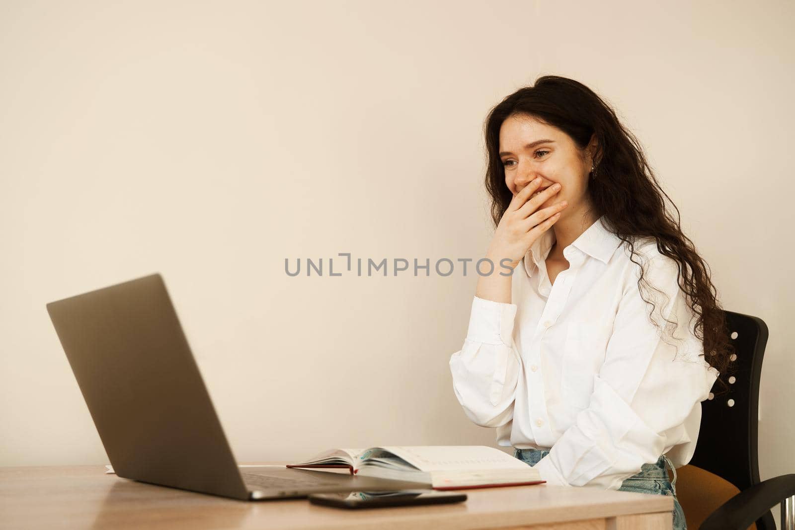 Surprised girl enjoying friendly video call on laptop computer using web camera for communicating. Video communication with colleagues at home. by Rabizo